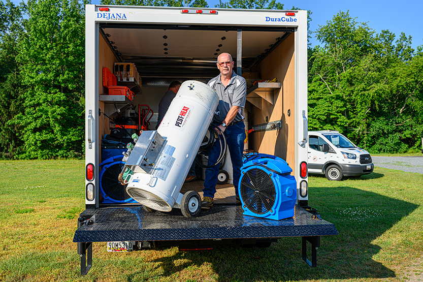 Bennett Termite & Pest Solutions Technician Holding a Heat Treatment Equipment | Bed Bug Control in Delaware, Maryland, and Virginia